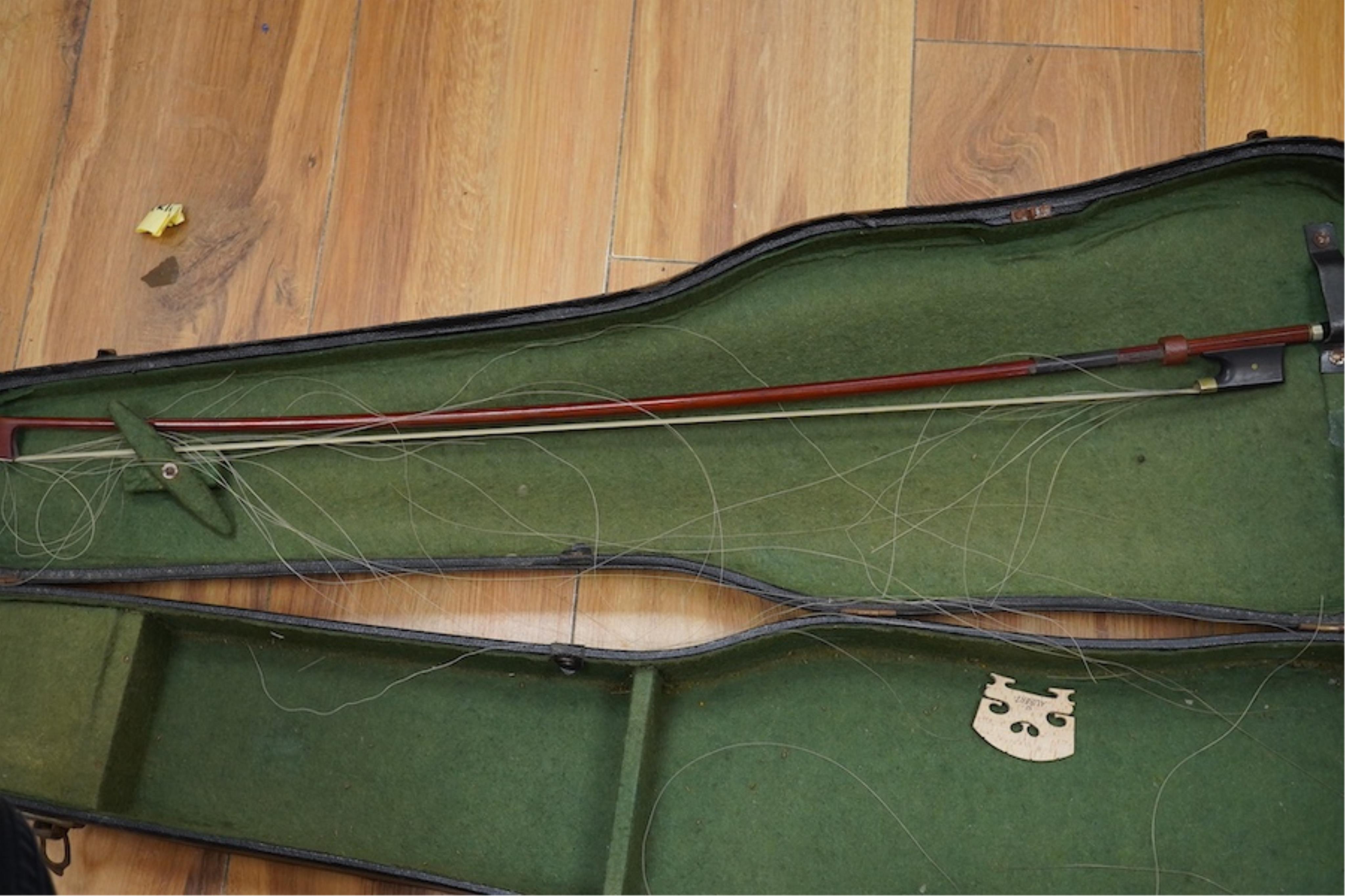 A late 19th cased century French unmarked violin and bow, body 35cm high.